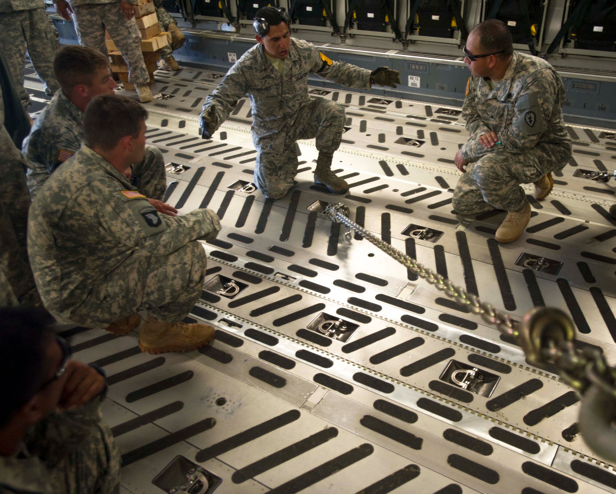 Staff Sgt. Omar Morales, 735th Air Mobility Squadron air freight technician, explains how to secure a Stryker onto a C-17 Globemaster III from the 535th Airlift Squadron to Soldiers from the 25th Infantry Division on the Joint Base Pearl Harbor-Hickam, Hawaii, flightline Aug. 13, 2014. The Stryker, the Army’s Interim Armored Vehicle, is used to provide quick response maneuvering capability, enhanced survivability and lethality and expand fight versatility. (U.S. Air Force photo by Tech. Sgt. Terri Paden)