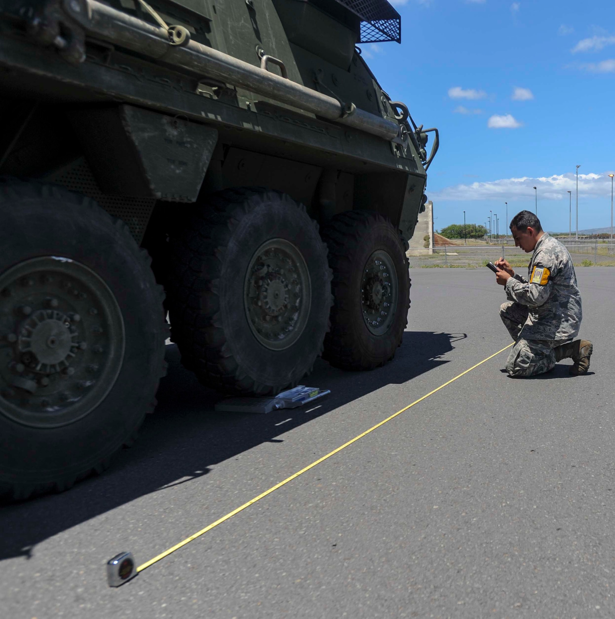 Staff Sgt. Omar Morales, 735th Air Mobility Squadron air freight technician, measures a Stryker on the Joint Base Pearl Harbor-Hickam, Hawaii, flightline Aug. 13, 2014, before loading it onto a C-17 Globemaster III from the 535th Airlift Squadron. The Stryker was at JBPHH to test the unit’s ability to deploy using the Stryker Marshalling Pad and Hot Cargo Pad. (U.S. Air Force photo by Tech. Sgt. Terri Paden)