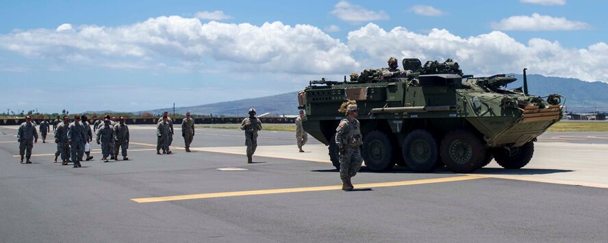 25th Infantry Division Soldiers escort a U.S. Army Stryker combat vehicle on the Joint Base Pearl Harbor-Hickam, Hawaii, flightline Aug. 13, 2014. The Stryker and the Soldiers were at JBPHH to test the unit’s ability to deploy using the Stryker Marshalling Pad and Hot Cargo Pad. (U.S. Air Force photo by Tech. Sgt. Terri Paden)