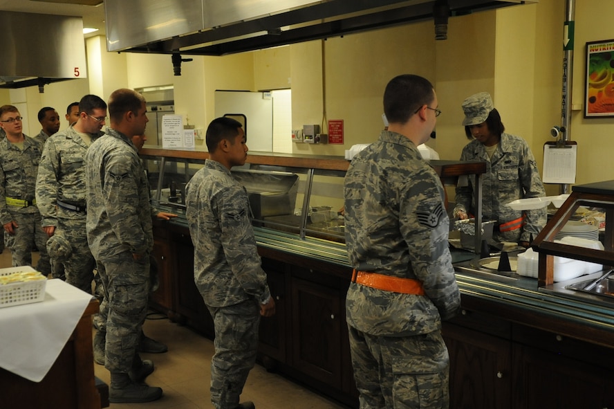 U.S. Air Force Airman 1st Class Amanda Dotson, 18th Force Support Squadron food service specialist, serves a line of Airmen at the Marshall Dining Facility on Kadena Air Base, Japan, Aug. 19, 2014. The facility is open from 10 p.m. to 12:30 a.m. to provide Airmen working late hours a meal to help them stay mission ready. (U.S. Air Force photo by Airman 1st Class Zackary A. Henry)