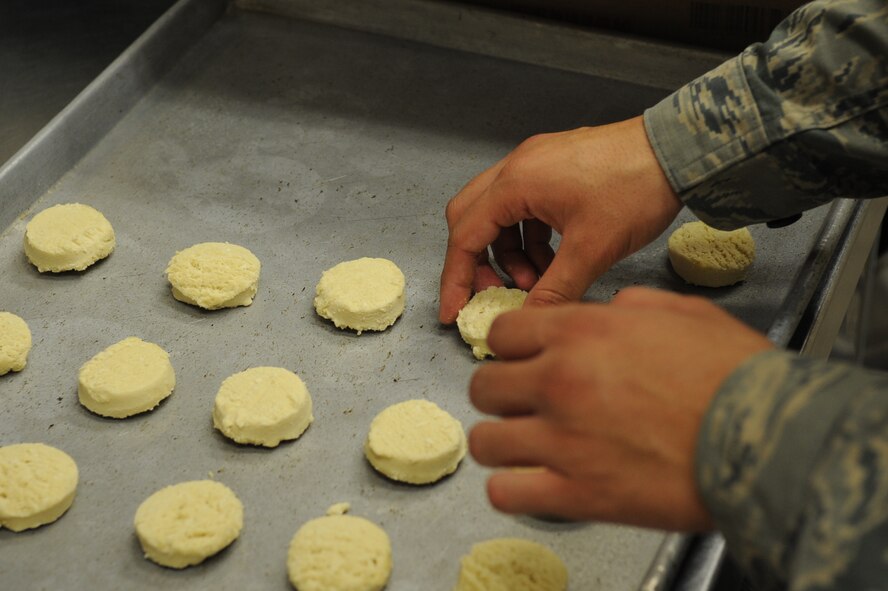 U.S. Air Force Airman Richard Bojorques, 18th Force Support Squadron food service specialist, prepares a pan of cookies at the Marshall Dining Facility on Kadena Air Base, Japan, Aug. 19, 2014. The dining facility offers a variety of food to provide Airmen choices to stay mission ready.  (U.S. Air Force photo by Airman 1st Class Zackary A. Henry)