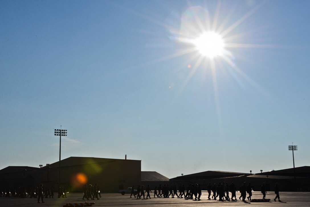 Airmen from the 28th Bomb Wing form a line on the flightline during the wing’s Foreign Object Debris walk at Ellsworth Air Force Base, S.D., Aug. 18, 2014. Groups of Airmen walked the runway and taxiways to ensure the area was free from any debris that could cause damage to aircraft. (U.S. Air Force photo by Senior Airman Zachary Hada/Released)