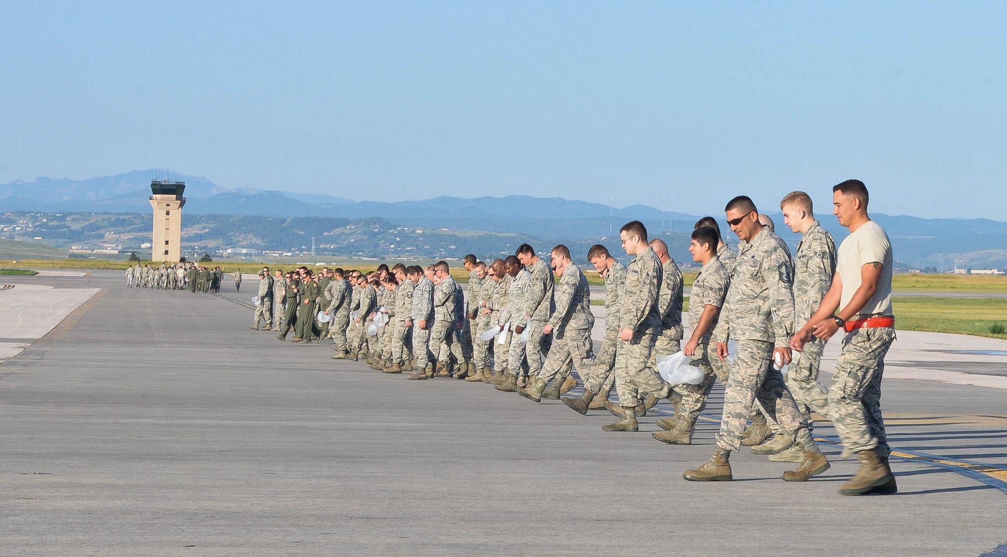 Airmen from the 28th Bomb Wing line-up on the flightline during the wing’s Foreign Object Debris walk at Ellsworth Air Force Base, S.D., Aug. 18, 2014. FOD walks ensure that all rocks, screws, or any misplaced items are cleared from the runway to prevent damage to aircraft engines. (U.S. Air Force photo by Senior Airman Zachary Hada/Released)