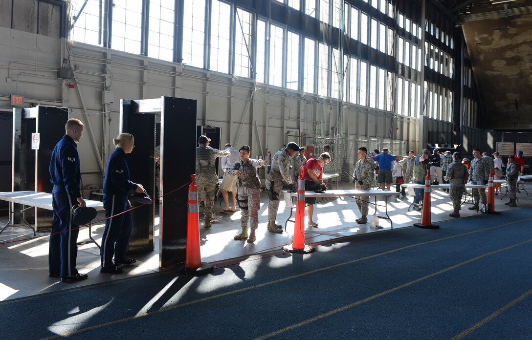 Airmen assigned to the 28th Security Forces Squadron perform security checks at the Pride Hangar during Ellsworth’s Black Hills Community Appreciation Day at Ellsworth Air Force Base, S.D., Aug. 16, 2014. The purpose of the event was to increase the community’s overall understanding of the base mission and Air Force lifestyle and thank them for their support over the years. (U.S. Air Force photo by Senior Airman Zachary Hada/Released)