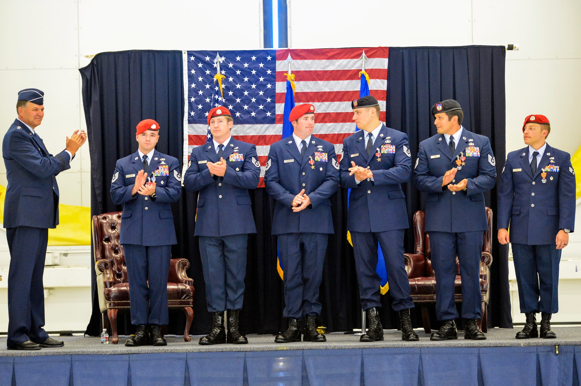 Lt. Gen. Bradley Heithold (left), Air Force Special Operations Command commander applauds six Airmen from the 22nd Special Tactics Squadron Aug. 18, 2014, after awarding them with medals for valor during the 22nd STS awards ceremony at Joint Base Lewis-McChord, Wash.  Heithold pinned eight medals on to the Airmen which included a Silver Star, a Bronze Star with Valor and four Bronze Stars. (U.S. Air Force photo/Staff Sgt. Russ Jackson)
