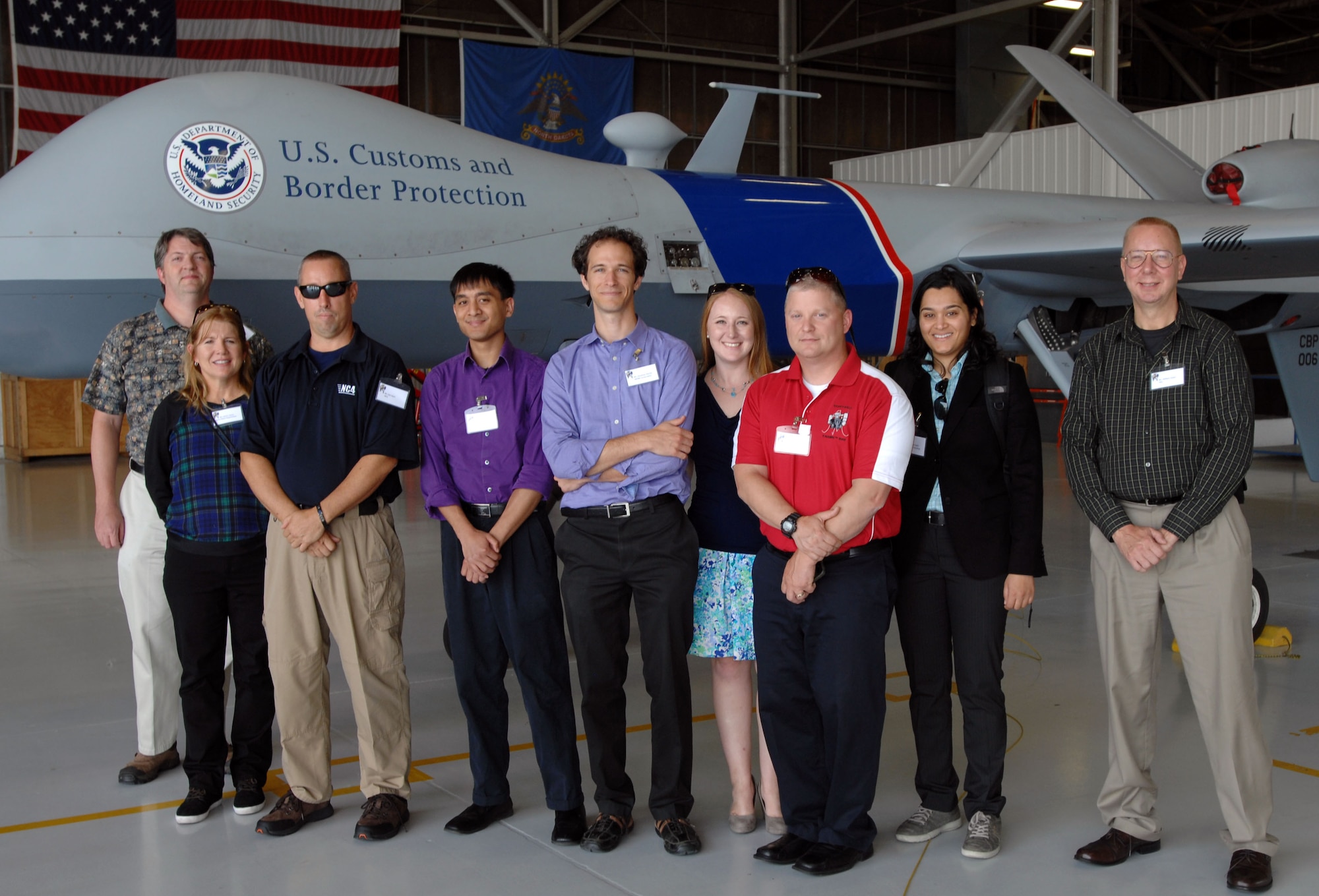 A group of civilians from the public and private sectors visit Grand Forks Air Force Base Aug. 13, 2014, to learn more about unmanned aircraft and how they could benefit their respective fields. The group had a briefing from the 348th Reconnaissance Group, followed by the North Dakota Air National Guard, Customs and Border Protection, Northrop Grumman and General Atomics. (U. S. Air Force photo/Staff Sgt. Susan L. Davis)