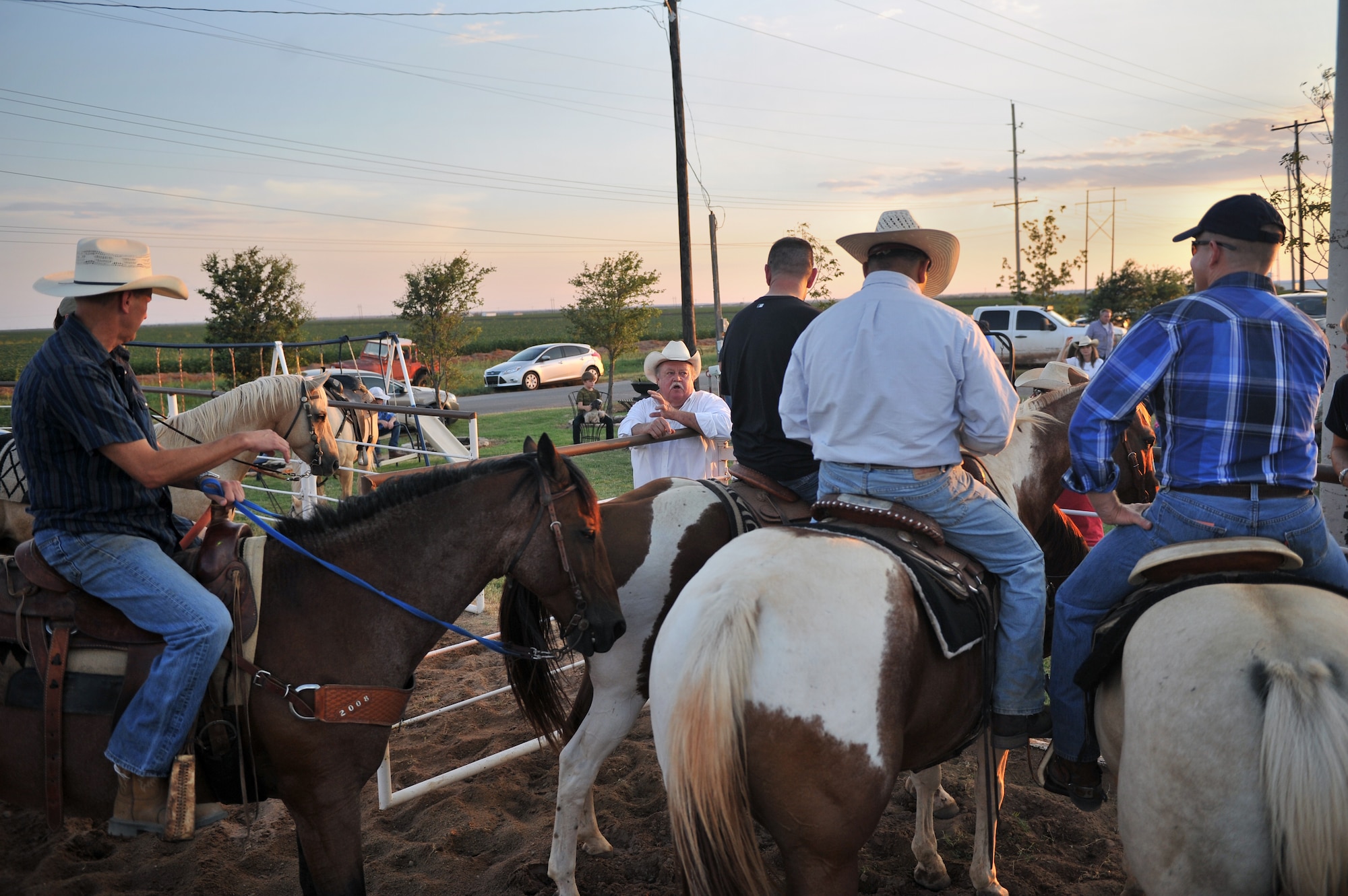 ALTUS, Okla. – Bull Watkins talks to 97th Air Mobility Wing leaders before the start of the annual Commander’s Cattle Sorting Competition held at Watkins’ Farm in Altus, Okla., Aug. 17, 2014. Watkins went over the rules and gave advice to help the commanders round up cattle on horseback. (U.S. Air Force photo by Senior Airman Dillon Davis/Released)