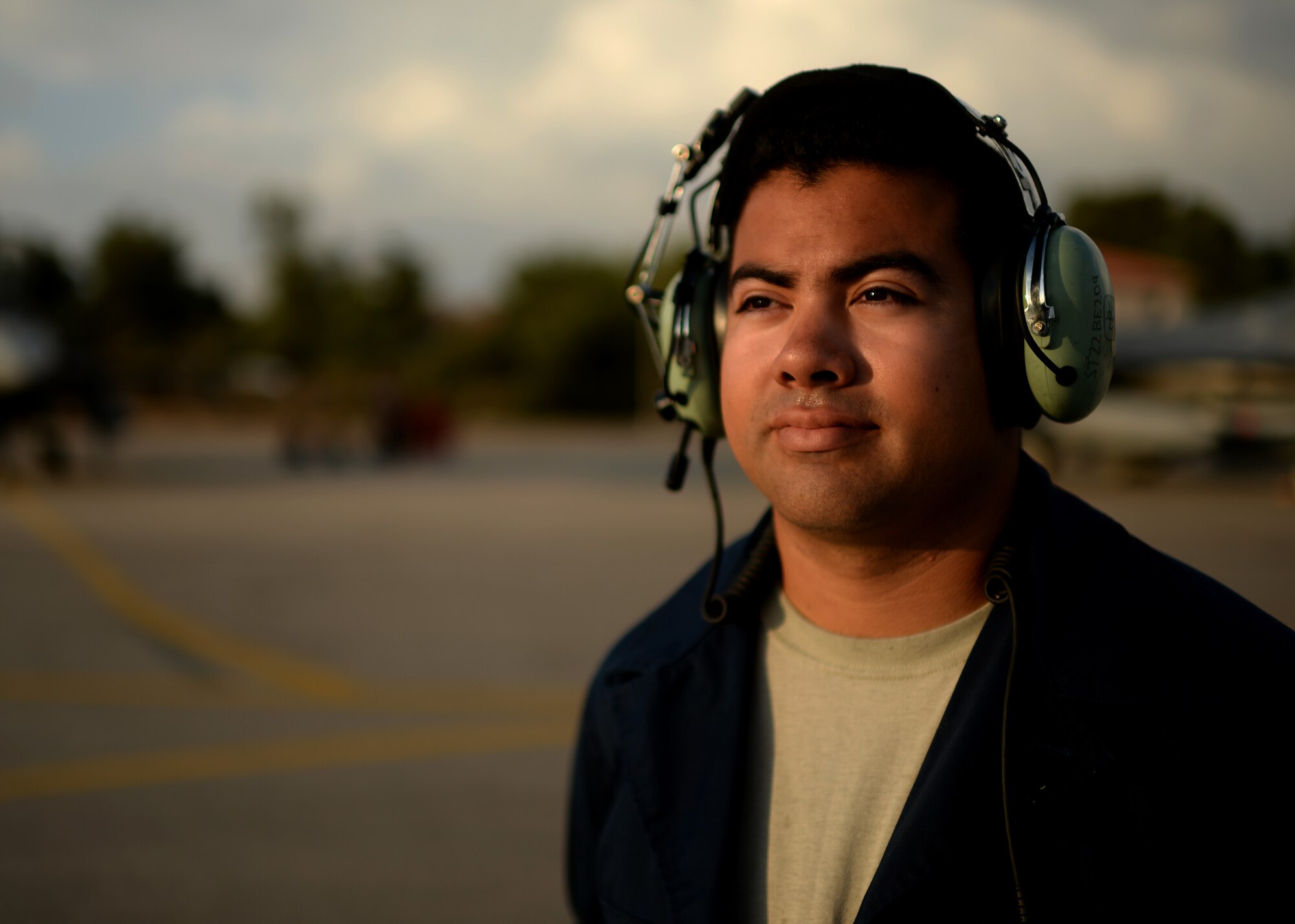 U.S. Air Force Senior Airman Miguel Dietrich, 52nd Aircraft Maintenance Unit crew chief and native of Independence, Calif., waits to marshal an F-16 Fighting Falcon fighter aircraft pilot to the flightline Aug. 18, 2014, during a training event between Greece and the U.S. (U.S. Air Force photo by Staff Sgt. Daryl Knee/Released)