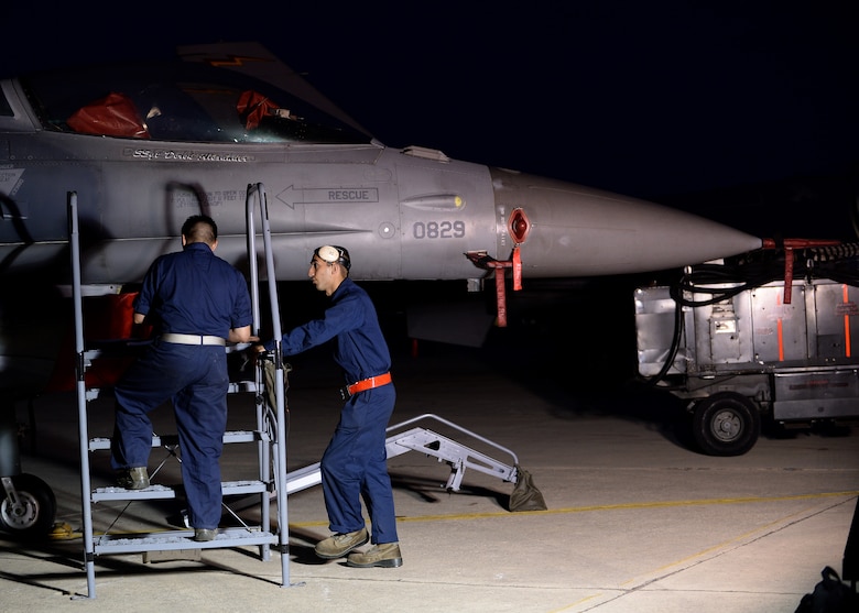 Two U.S. Air Force Airmen talk about the morning's preparation for the day's first F-16 Fighting Falcon fighter aircraft launch Aug. 18, 2014, at Souda Bay, Greece. This is the second week of training between the U.S. and Hellenic air forces. (U.S. Air Force photo by Staff Sgt. Daryl Knee/Released)