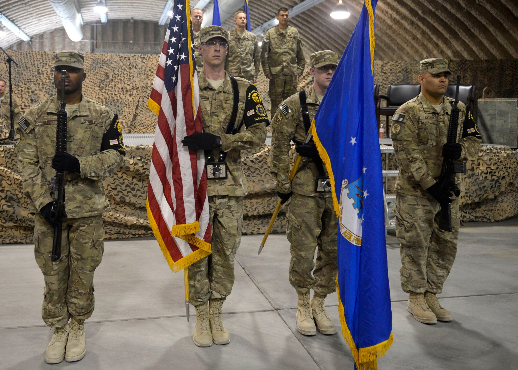U.S. Airmen from the 451st Air Expeditionary Group Honor Guard present the colors during the 451 AEG change of command ceremony at Kandahar Airfield, Afghanistan Aug. 18, 2014. Airmen across the group attended the ceremony to welcome Col. Rhude Cherry III as their new commander. (U.S. Air Force photo by Staff Sgt. Evelyn Chavez/Released)