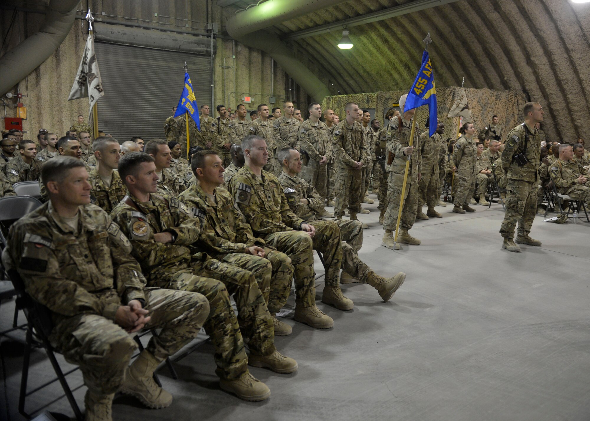 U.S. Airmen from the 451st Air Expeditionary Group listen to their new commander during a change of command ceremony at Kandahar Airfield, Afghanistan Aug. 18, 2014. Airmen across the group attended the ceremony to welcome Col. Rhude Cherry III as their new commander. (U.S. Air Force photo by Staff Sgt. Evelyn Chavez/Released)