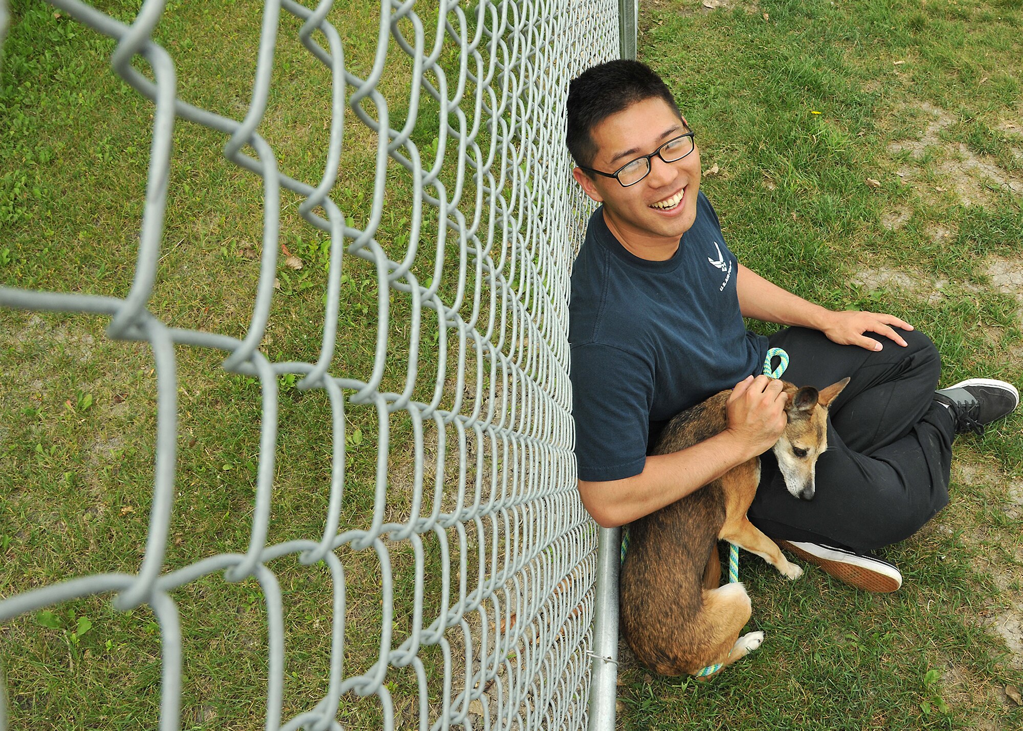 Airman 1st Class Namhoon Kim, 319th Logistics Readiness Squadron customer support apprentice, pets Sherri, a German shepherd, at the Circle of Friends Humane Society Aug. 6, 2014, in Grand Forks, N.D. The local animal shelter’s mission is to house and care for lost and unwanted animals, to place them into loving homes and to implement programs which increase awareness of volunteers’ responsibilities to all animals. (U.S. Air Force photo/Senior Airman Xavier Navarro)