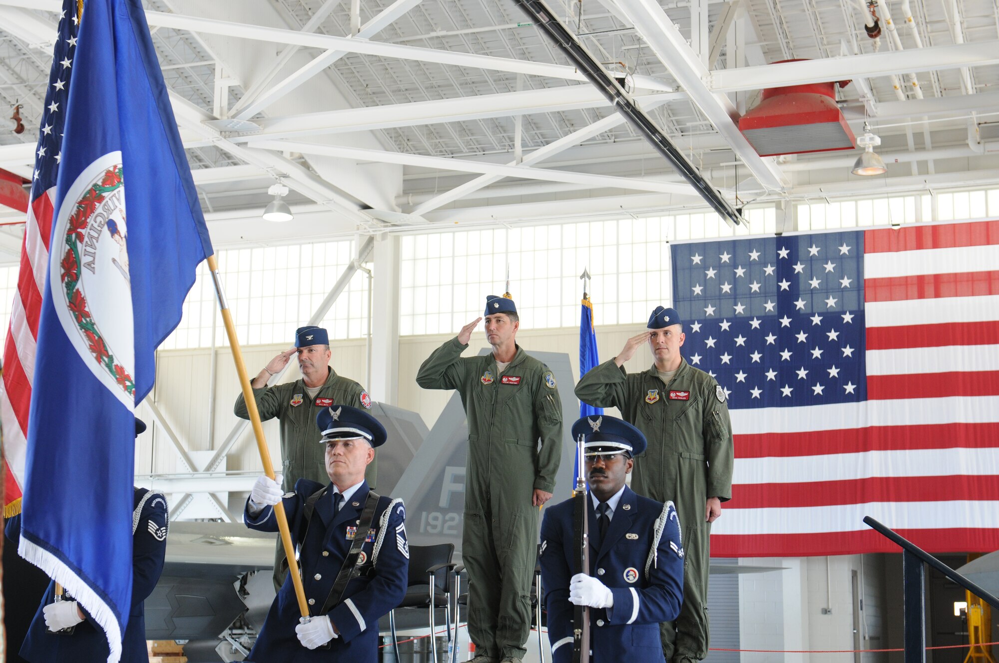 Col. William J. Butz, 192nd Operations Group commander, presents the squadron colors to Lt. Col. Micah Fesler, signifying the transfer of command of the 149th Fighter Squadron, during a change of command ceremony held July 12, 2014 at Joint Base Langley-Eustis. (U.S. Air National Guard photo by 2nd Lt. Meaghan E. M. Selki/Released)