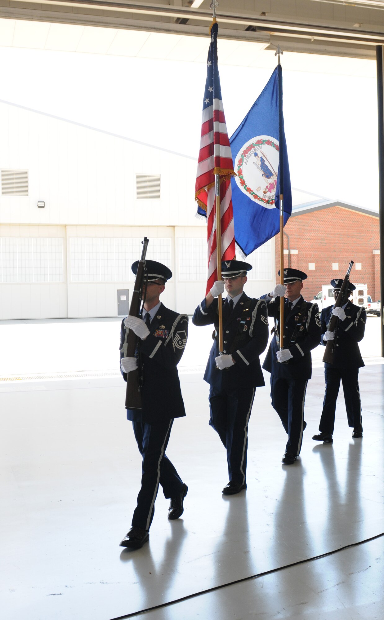 Col. William J. Butz, 192nd Operations Group commander, presents the squadron colors to Lt. Col. Micah Fesler, signifying the transfer of command of the 149th Fighter Squadron, during a change of command ceremony held July 12, 2014 at Joint Base Langley-Eustis. (U.S. Air National Guard photo by 2nd Lt. Meaghan E. M. Selki/Released)