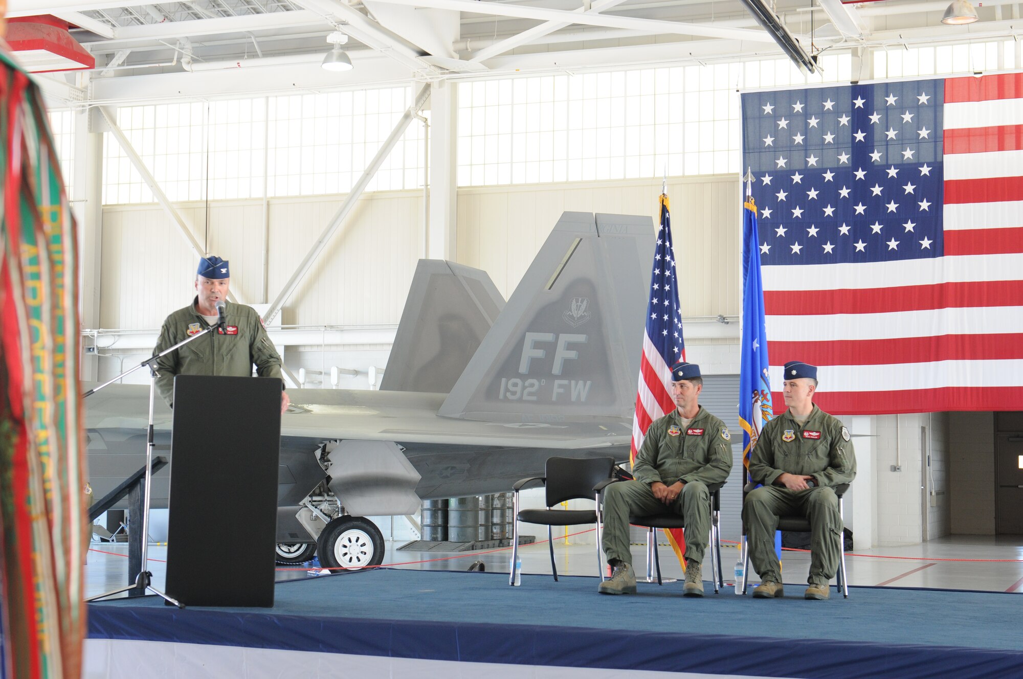 Col. William J. Butz, 192nd Operations Group commander, presents the squadron colors to Lt. Col. Micah Fesler, signifying the transfer of command of the 149th Fighter Squadron, during a change of command ceremony held July 12, 2014 at Joint Base Langley-Eustis. (U.S. Air National Guard photo by 2nd Lt. Meaghan E. M. Selki/Released)