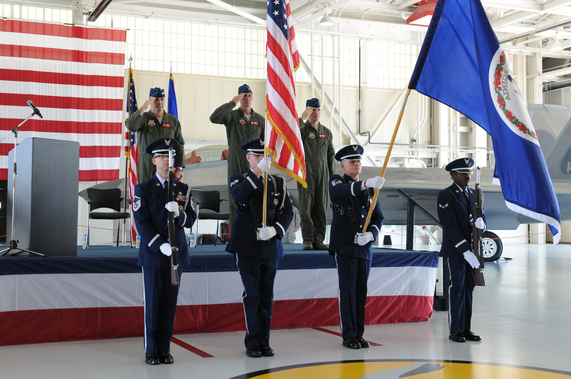 Col. William J. Butz, 192nd Operations Group commander, presents the squadron colors to Lt. Col. Micah Fesler, signifying the transfer of command of the 149th Fighter Squadron, during a change of command ceremony held July 12, 2014 at Joint Base Langley-Eustis. (U.S. Air National Guard photo by 2nd Lt. Meaghan E. M. Selki/Released)