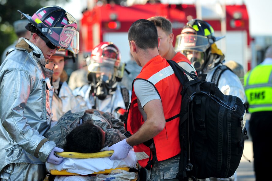 4th Fighter Wing emergency responders transport a victim of a mock KC-135R Stratotanker crash during a Major Accident Response Exercise in Goldsboro, North Carolina, Aug. 14, 2014. Seymour Johnson Air Force Base partnered with Goldsboro and Wayne County first responders for a two-day exercise designed to test the effectiveness of both the base and local authorities to a military incident in the Goldsboro area. (U.S. Air Force photo/Airman 1st Class Shawna Keyes)