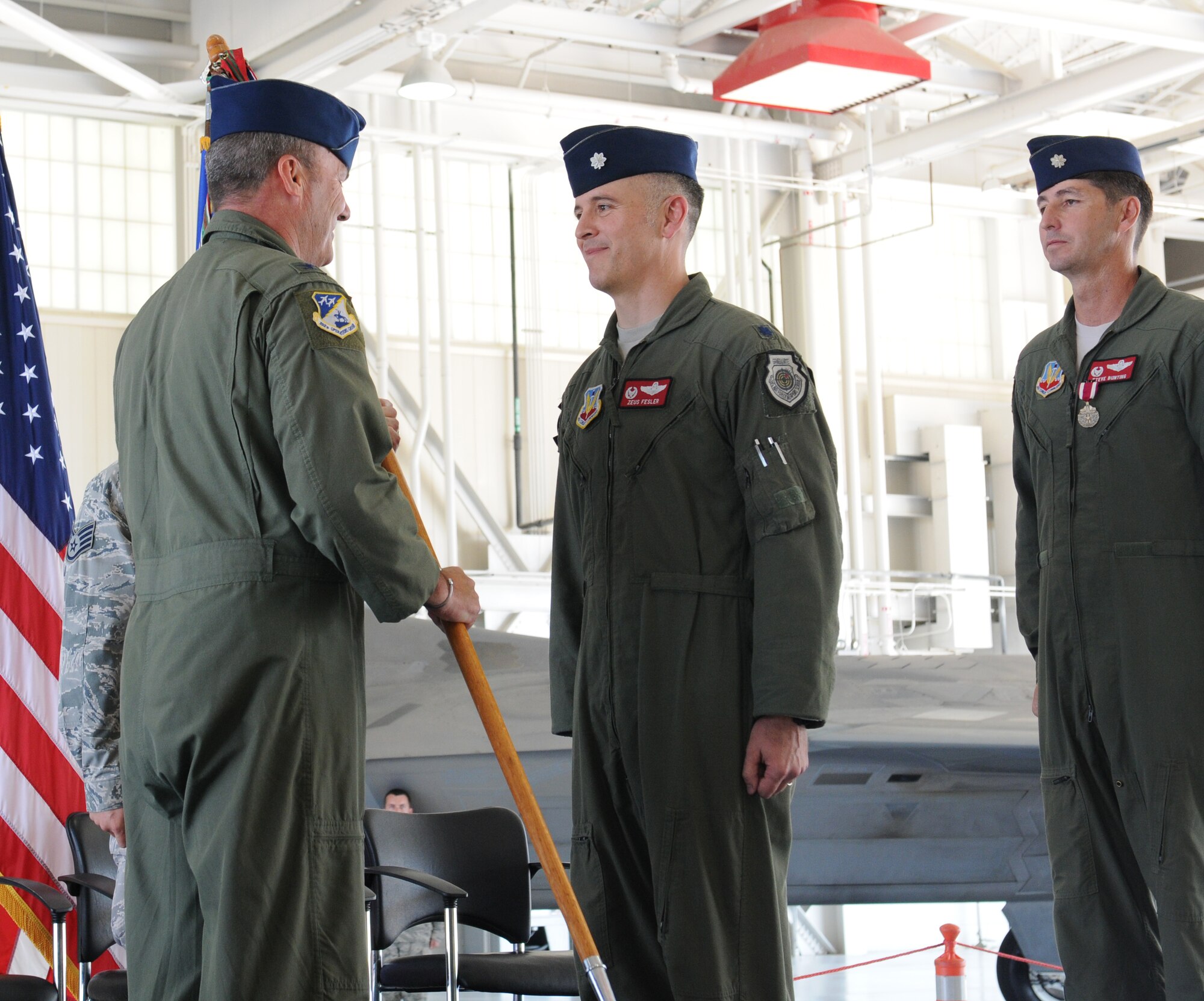 Col. William J. Butz, 192nd Operations Group commander, presents the squadron colors to Lt. Col. Micah Fesler, signifying the transfer of command of the 149th Fighter Squadron, during a change of command ceremony held July 12, 2014 at Joint Base Langley-Eustis. (U.S. Air National Guard photo by 2nd Lt. Meaghan E. M. Selki/Released)