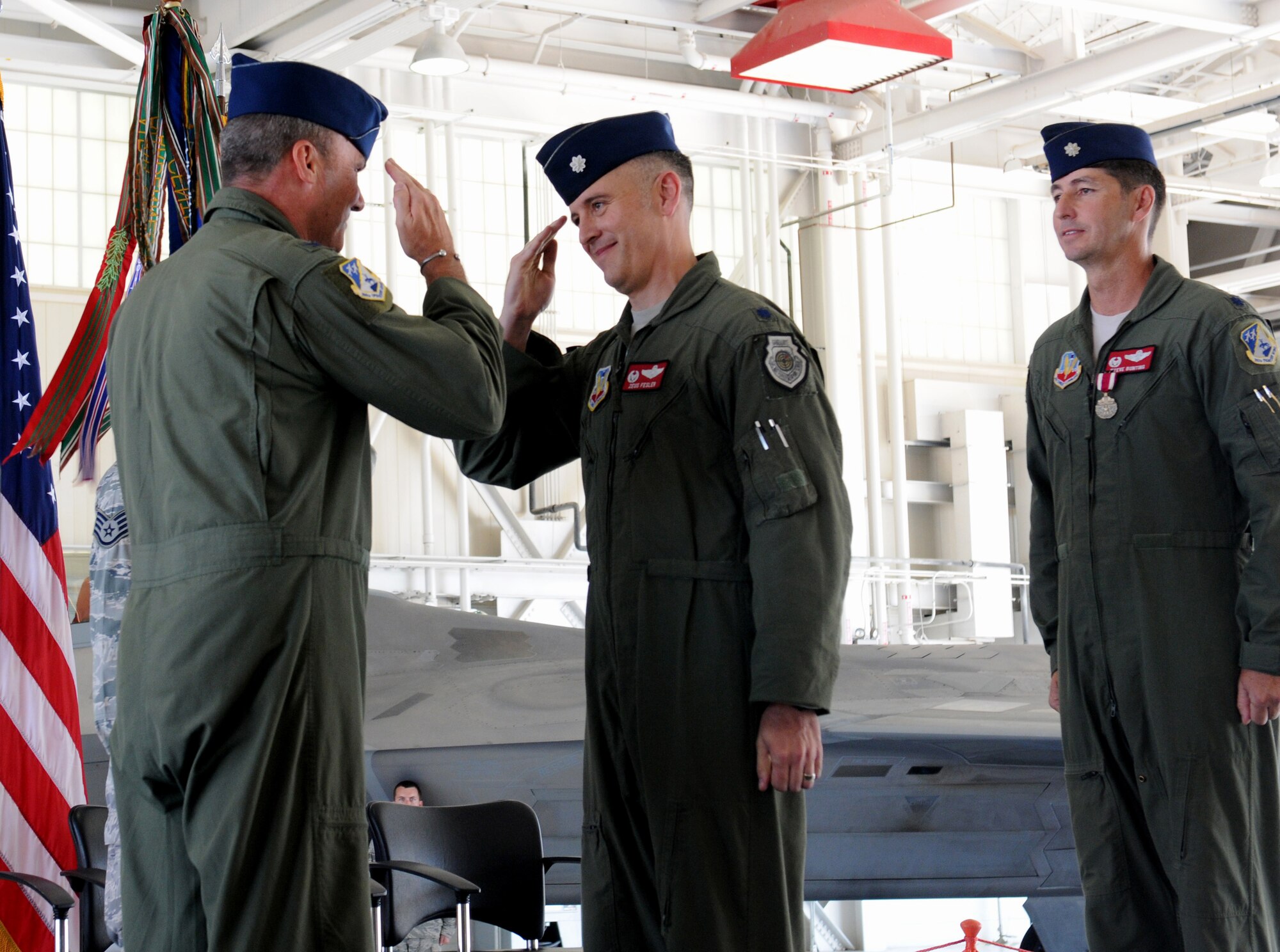 Col. William J. Butz, 192nd Operations Group commander, presents the squadron colors to Lt. Col. Micah Fesler, signifying the transfer of command of the 149th Fighter Squadron, during a change of command ceremony held July 12, 2014 at Joint Base Langley-Eustis. (U.S. Air National Guard photo by 2nd Lt. Meaghan E. M. Selki/Released)