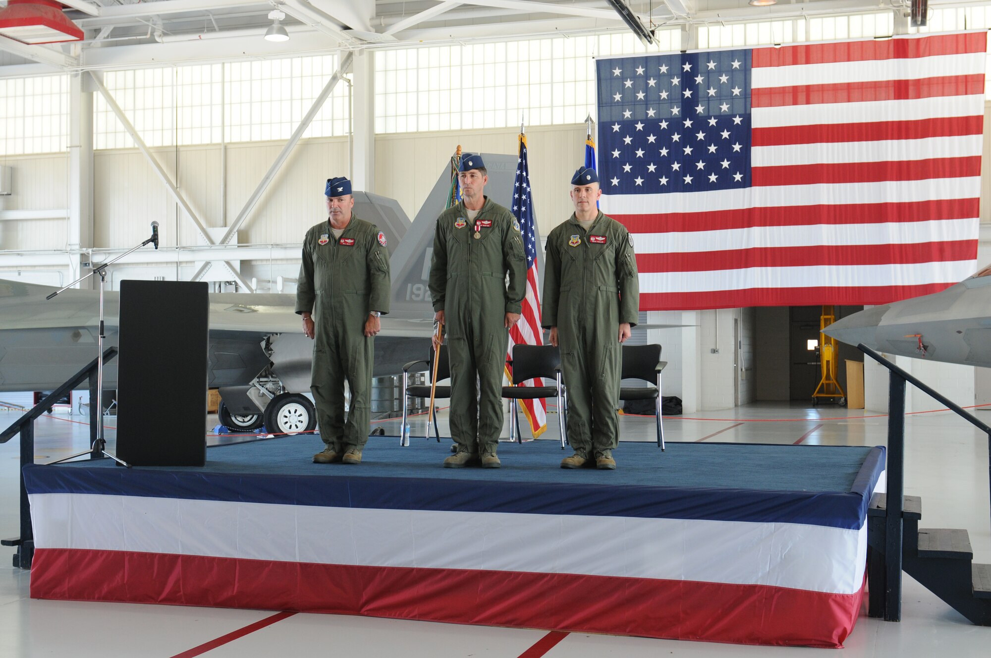 Col. William J. Butz, 192nd Operations Group commander, presents the squadron colors to Lt. Col. Micah Fesler, signifying the transfer of command of the 149th Fighter Squadron, during a change of command ceremony held July 12, 2014 at Joint Base Langley-Eustis. (U.S. Air National Guard photo by 2nd Lt. Meaghan E. M. Selki/Released)