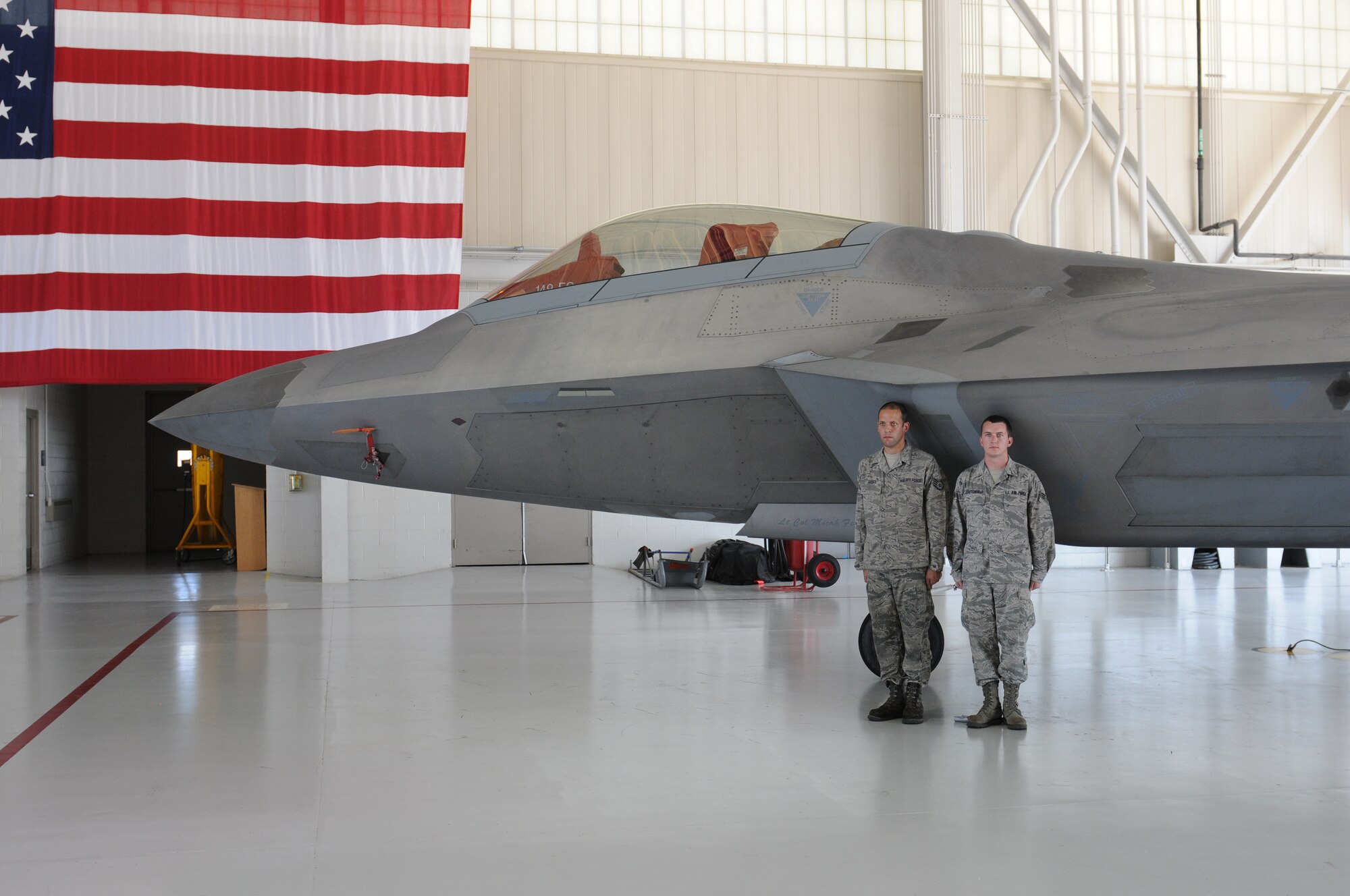Col. William J. Butz, 192nd Operations Group commander, presents the squadron colors to Lt. Col. Micah Fesler, signifying the transfer of command of the 149th Fighter Squadron, during a change of command ceremony held July 12, 2014 at Joint Base Langley-Eustis. (U.S. Air National Guard photo by 2nd Lt. Meaghan E. M. Selki/Released)