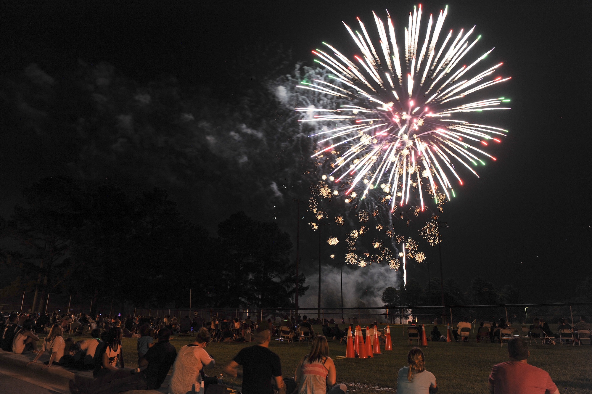 Team Seymour enjoys the firework show during the Summer Time Blast on Aug. 15, 2014, at Seymour Johnson Air Force Base, North Carolina. The event featured fireworks, live music, food, and family games and entertainment. (U.S. Air Force photo/Airman 1st Class Aaron J. Jenne)
