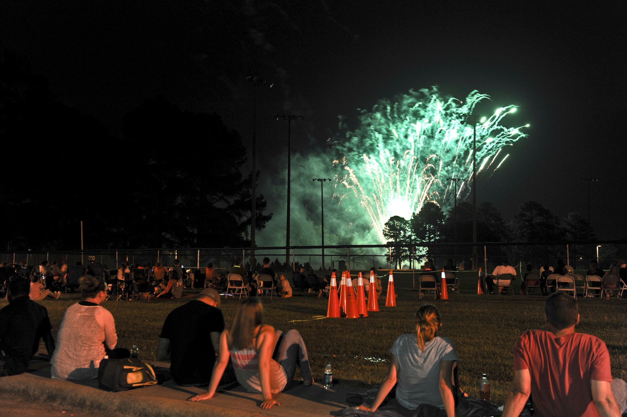 Team Seymour enjoys the firework show during the Summer Time Blast on Aug. 15, 2014, at Seymour Johnson Air Force Base, North Carolina. The event featured fireworks, live music, food, and family games and entertainment. (U.S. Air Force photo/Airman 1st Class Aaron J. Jenne)