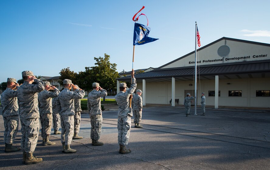 Airmen salute the flag during reveille at the Eglin Professional Development Center Aug. 14. The current class graduates Aug. 26 from Airman Leadership School as part of their month-long path to becoming a non-commissioned officer. Roughly every two to three weeks ALS begins a new class, averaging seven classes a year. (U.S. Air Force photo/ Tech. Sgt. Jasmin Taylor)