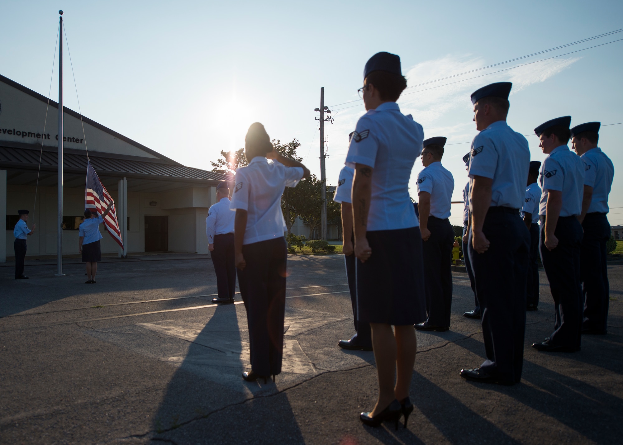 Airmen salute the flag during reveille at the Eglin Professional Development Center Aug. 14. The current class graduates Aug. 26 from Airman Leadership School as part of their month-long path to becoming a non-commissioned officer. Roughly every two to three weeks ALS begins a new class, averaging seven classes a year. (U.S. Air Force photo/ Tech. Sgt. Jasmin Taylor)