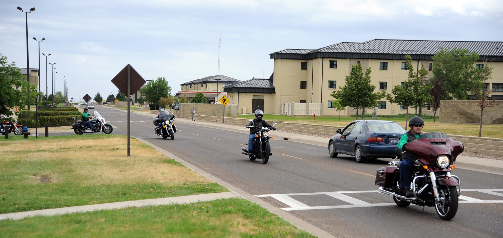 Malmstrom motorcycle riders head to the front gate to start the 139-mile drive around 11:30 a.m. at Malmstrom Air Force Base, Mont., leaving in small groups of about six to eight bikes. The 2014 Rolling Thunder safety event included a drive that took riders through a loop up to Wolf Creek and back through Vaughn, Mont. (U.S. Air Force photo/Airman 1st Class Joshua Smoot)