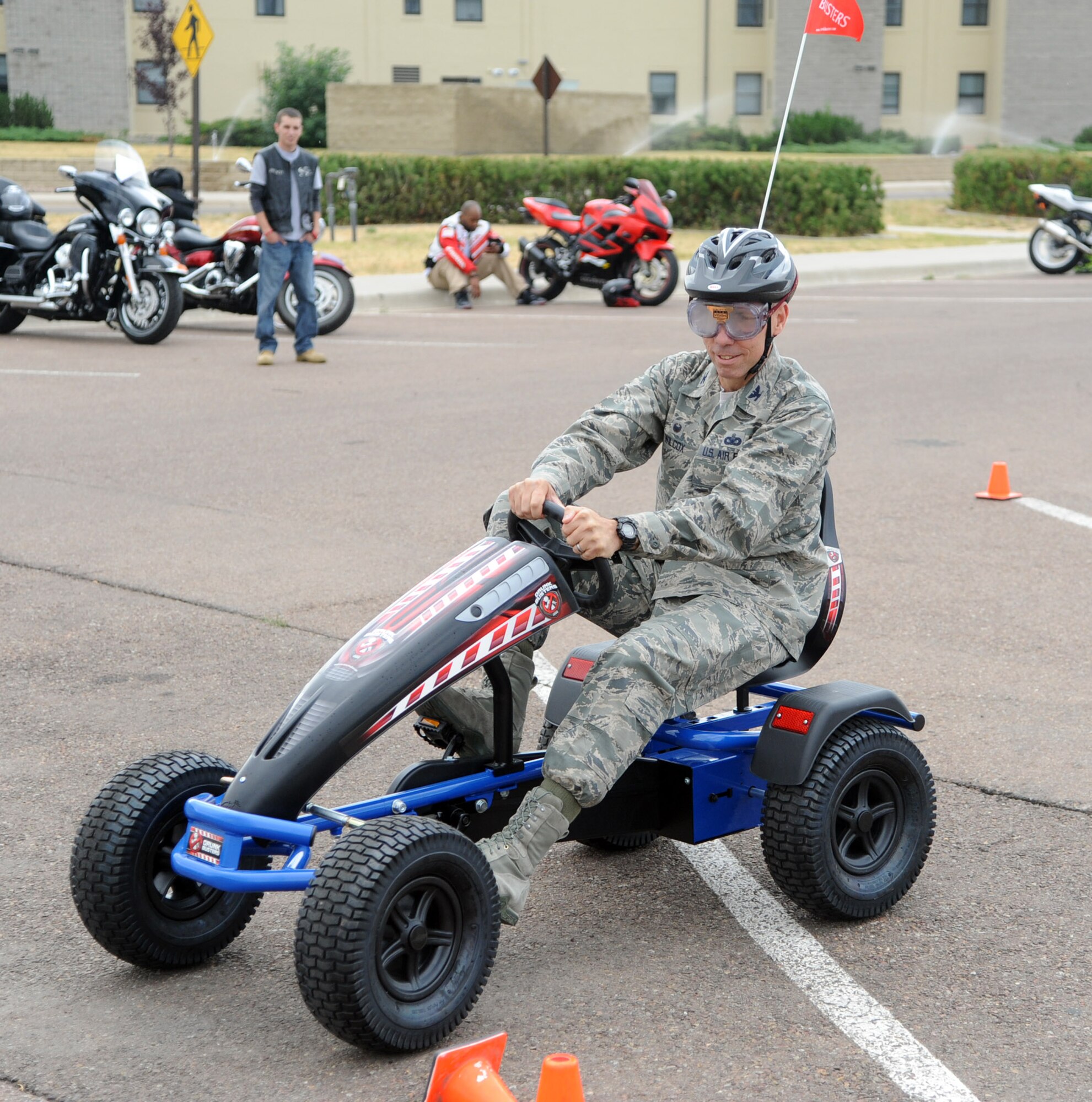 Col. Tom Wilcox, 341st Missile Wing commander, rides through an obstacle course during the 2014 Rolling Thunder motorcycle safety event at Malmstrom Air Force Base, Mont. Aug. 14. Riders were given the opportunity to ride through an obstacle course while wearing goggles that simulated being under the influence of alcohol. (U.S. Air Force photo/Airman 1st Class Joshua Smoot)