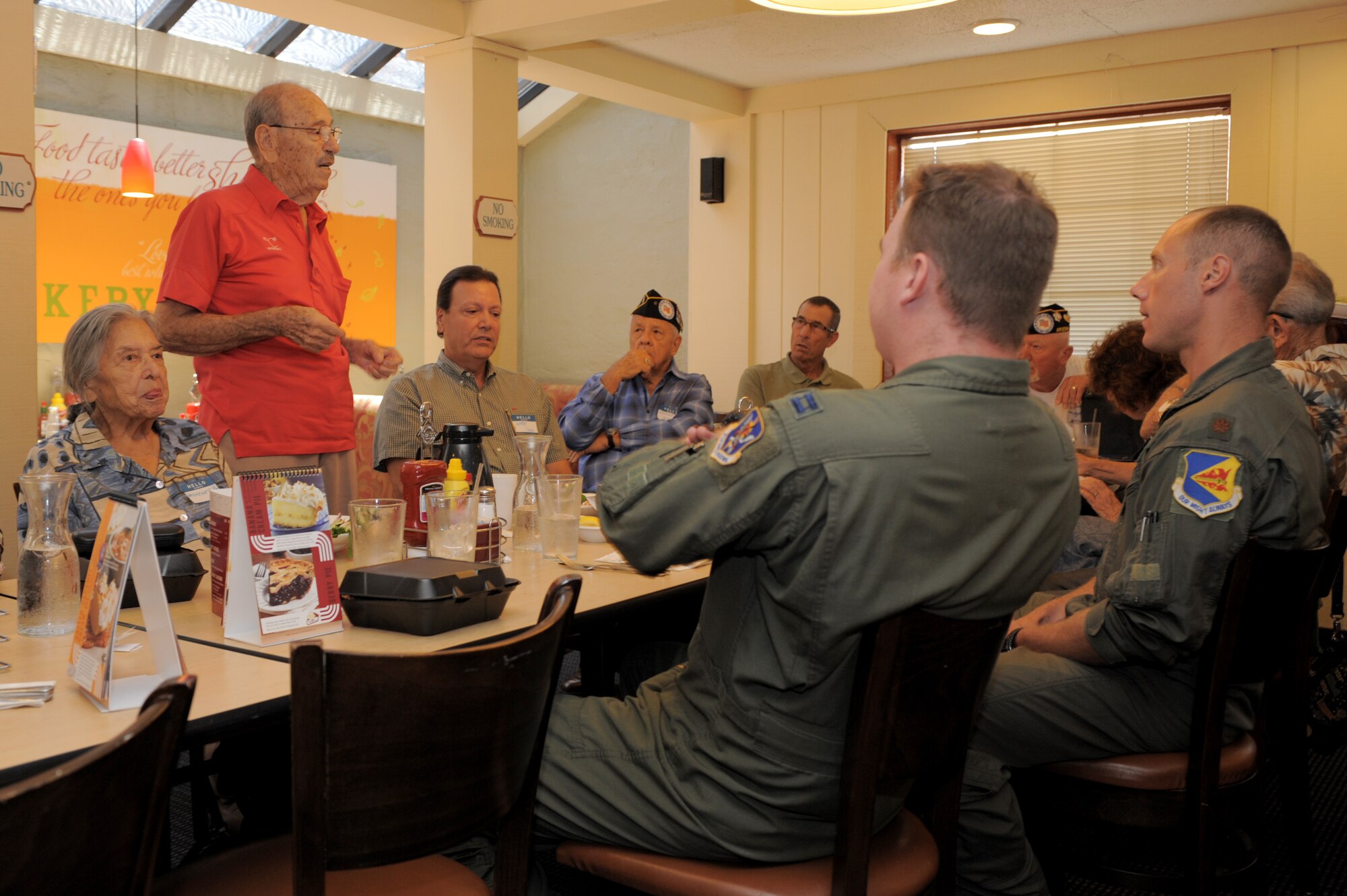 Walter F. Ram, former World War II prisoner of war, converses with pilots from Davis-Monthan during a lunch in Tucson, Ariz., Aug. 13, 2014. Ram was aboard an aircraft that was shot down by Nazi fighter planes during a bomb mission in 1943, which began his 19 months as a prisoner of war. (U.S. Air Force photo by Airman 1st Class Chris Drzazgowski/Released)