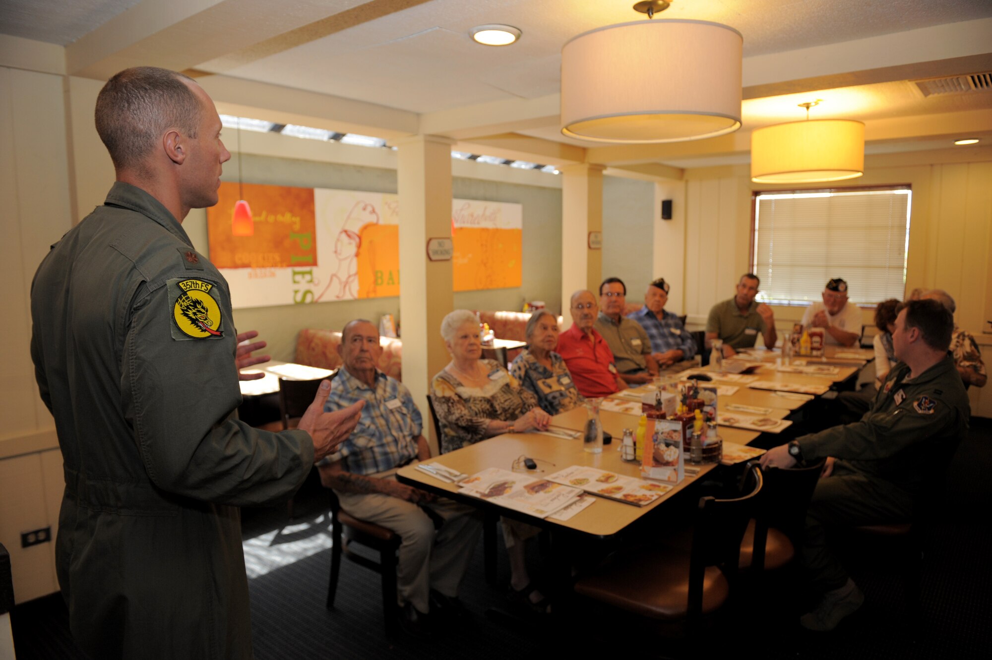 U.S. Air Force Maj. Christopher Palmer, 357th Fighter Squadron A-10 pilot, discusses his squadron’s mission to members of the Veterans of Underage Military Service organization during a lunch in Tucson, Ariz., Aug. 13, 2014. The lunch was arranged for Davis-Monthan personnel and members of VUMS to share their stories with one another. (U.S. Air Force photo by Airman 1st Class Chris Drzazgowski/Released)