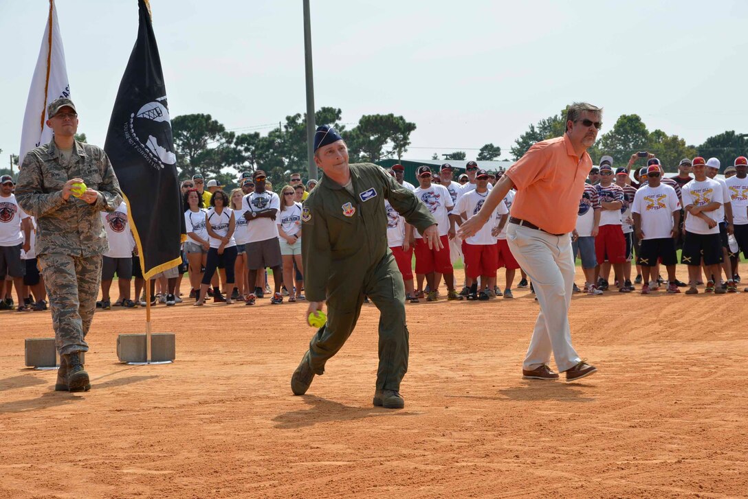 (From Left) Chaplain (Capt.) Rudy Olivo, 601st Air and Space Operations Center, Brig. Gen. David Hicks, Air Forces Northern Vice Commander and Dan Rowe, Panama City Beach civic leader, prepare to toss the ceremonial “first pitch” during the opening ceremonies of the 2014 United States Specialty Sports Association Military World Softball Tournament August 14. The four-day event, held at Frank Brown Park, Panama City Beach, attracts more than 100 military slow-pitch teams from all the U.S. military services around the world. (U.S. Photo by Master Sgt. Kurt Skoglund/Released)