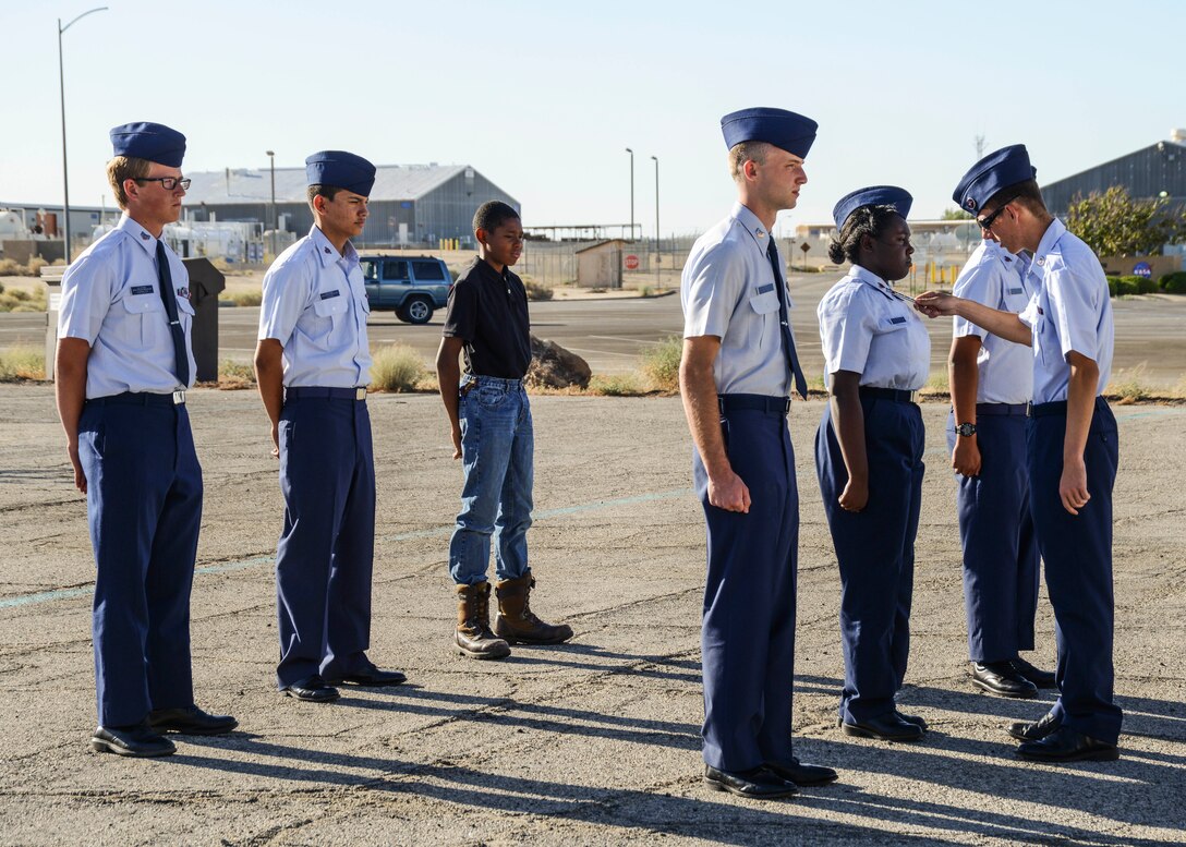 Leaders of Civil Air Patrol Squadron 84 perform routine uniform checks during a weekly meeting on Edwards Air Force Base. Individuals interested in joining the Civil Air Patrol may attend a Squadron 84 weekly meeting, which are held Tuesdays from 6 p.m. to 8 p.m. at 1518 Forbes Ave., bldg.1850. (U.S. Air Force photo by Rebecca Amber) 