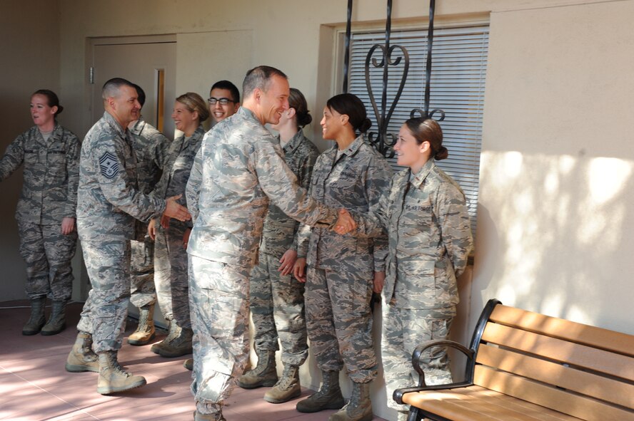 Chief Master Sgt. John Mazza, 56th Fighter Wing command chief, and Brig. Gen. Scott Pleus, 56th FW commander, congratulate the 56th Medical Group nurses who graduated from the Critical Care and Emergency Trauma Nursing Fellowship program. The yearlong program to train in intensive, trauma and emergency care ended Aug. 7. (U.S. Air Force photo/Airman 1st Class James Hensley)