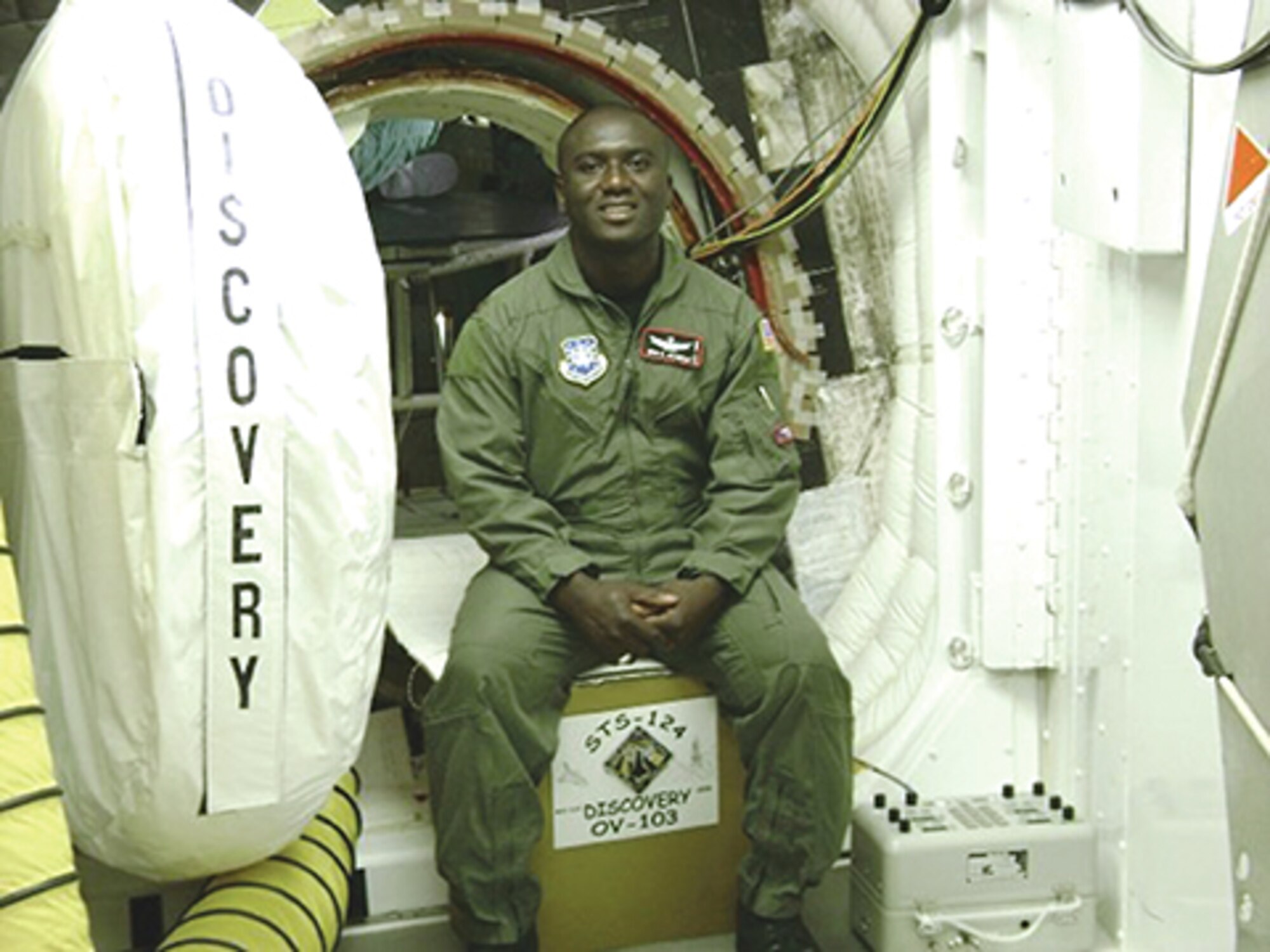 Lt. Col. Eric Amissah sits in the open hatch to the space shuttle Discovery during his time stationed at Cape Canaveral, Fla. (Courtesy photo)