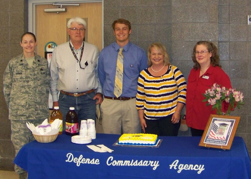 U.S. Air Force Lt. Col. Joyce Storm, 27th Special Operations Mission Support Group deputy commander, stands with this year’s Defense Commissary Agency scholarship winner Elliot Pelfrey, his parents, Gerald and Shawn Pelfrey, and Deborah Dickerson, 27th Special Operations Mission Support Group commissary manager Aug. 8, 2014 at Cannon Air Force Base, N.M. The Defense Commissary Agency sponsors a scholarship yearly that has given out more than $14 million to help military dependents with the cost of college. (U.S. Air Force photo/Senior Airman Ericka Engblom)
