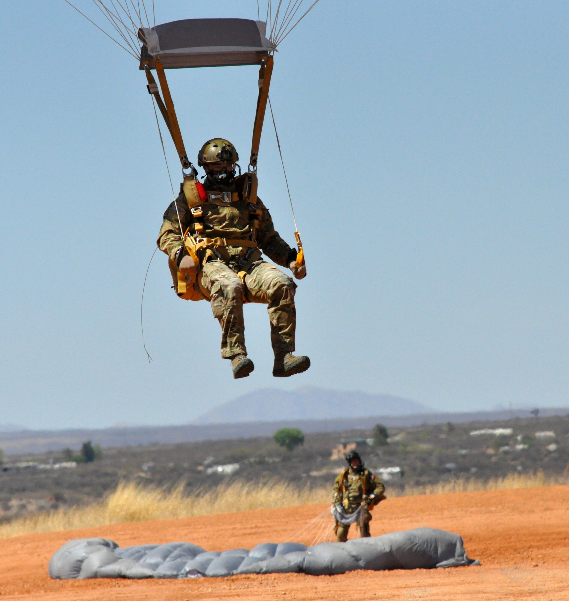 A pararescueman from the 306th Rescue Squadron lands at a drop zone during a HALO (High Altitude Low Opening) jump training exercises. The 306th Rescue Squadron is an Air Force Reserve unit assigned to the 943rd Rescue Group at Davis-Monthan Air Force Base, Ariz. The 306th RQS is a pararescue squadron that trains to maintain the capability to perform day or night rescue missions in any adverse weather conditions and their motto is "That Others May Live." (U.S. Air Force Photo/ Staff Sgt. Sarah Pullen)