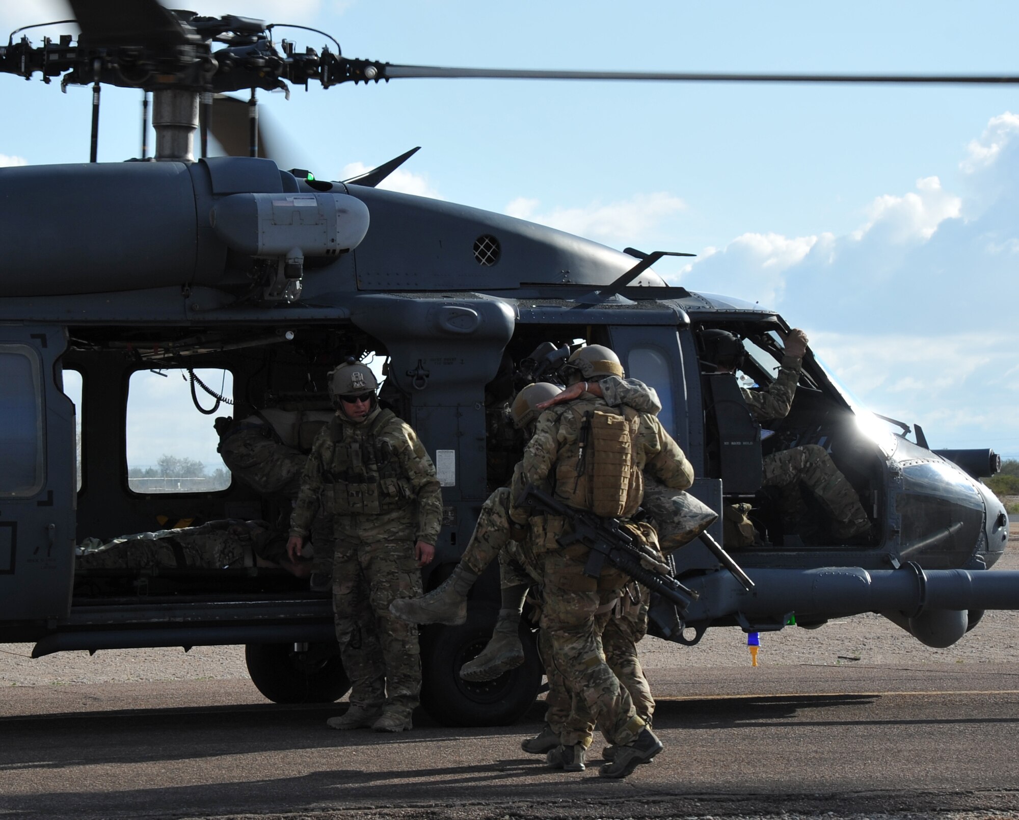 Pararescuemen from the 306th Rescue Squadron load patients on a HH-60G Pave Hawk from the 305th Rescue Squadron helicopter during a pre-deployment training exercise in December 2011. Both the 305th and 306th Rescue Squadrons are part of the 943rd Rescue Group, which is the only rescue group in the entire Air Force Reserve. It's mission is to train personnel, with equipment, to achieve and maintain the capability to perform day or night combat rescue missions; search for, locate and recover U.S. Air Force and other Department of Defense personnel involved with U.S. defense activities; provide search and rescue support of civilians as directed by the Air Force Rescue Coordination Center; and provide humanitarian and disaster relief operations. (U.S. Air Force Photo/ Master Sgt. Luke Johnson)