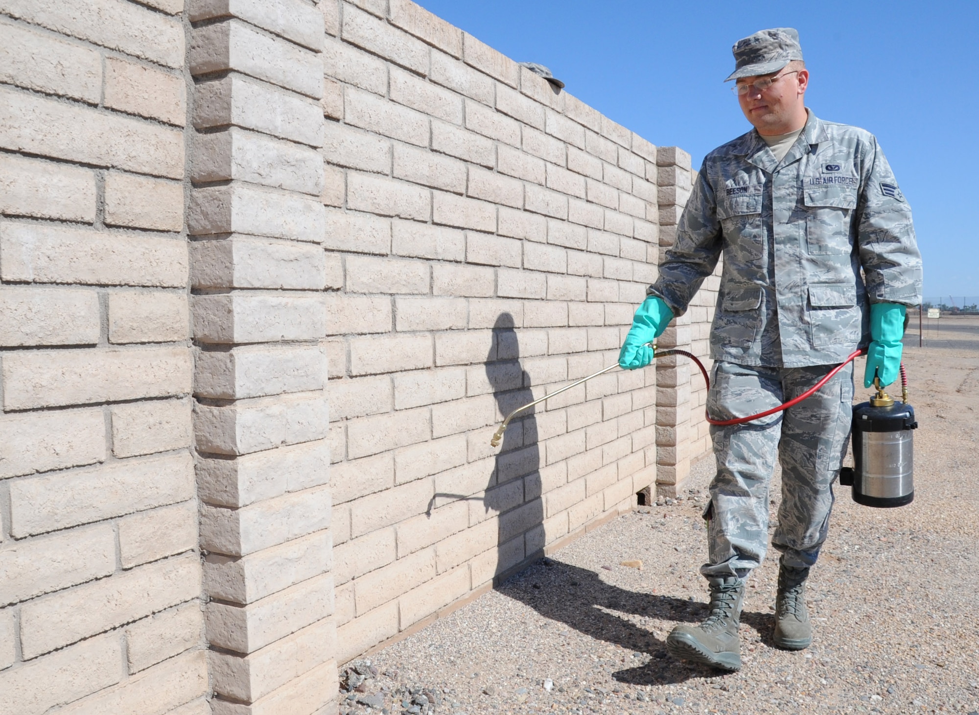 Senior Airman Stephen Beeson, 56th Civil Engineer Squadron pest management journeyman, sprays pesticide around the perimeter of the entomology building Aug. 8. Entomologist perform a variety of duties to help fight pests, including performing public health inspections, controlling the weed population and assisting the Bird Abatement Strike Hazard program. (U.S. Air Force photo/Staff Sgt. Luther Mitchell Jr.)