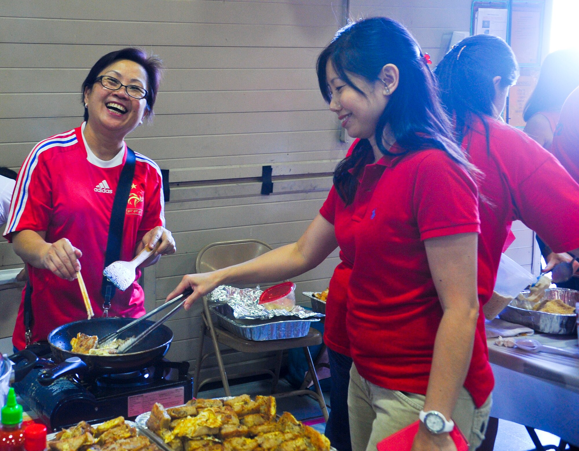 Singaporeans prepare food for the celebration feast. National day is a celebration of Singapore’s independence from Malaysia in 1965. (U.S. Air Force photo/Airman 1st Class Cory Gossett)