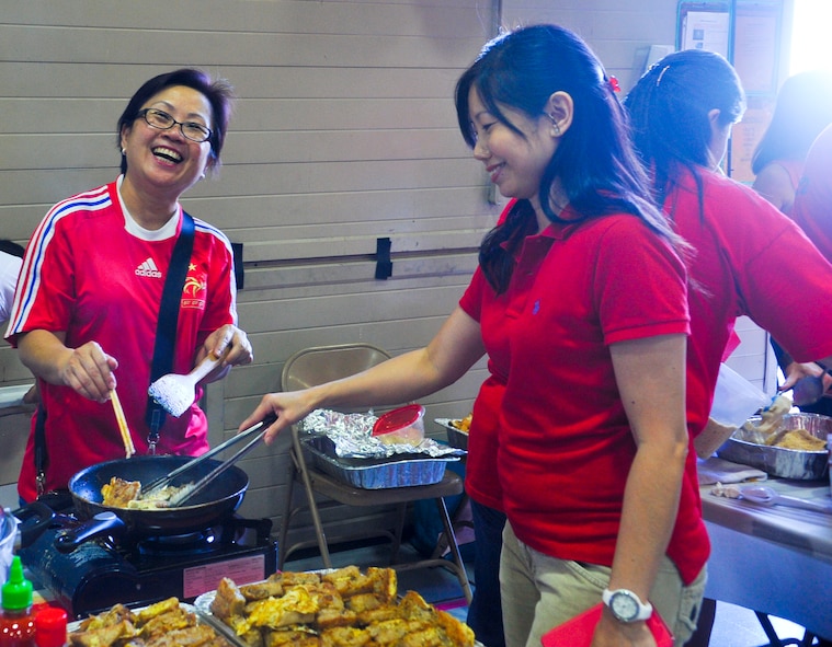 Singaporeans prepare food for the celebration feast. National day is a celebration of Singapore’s independence from Malaysia in 1965. (U.S. Air Force photo/Airman 1st Class Cory Gossett)