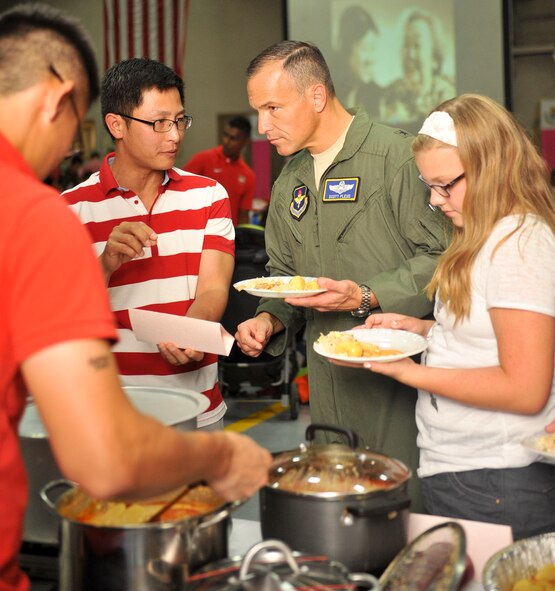 Traditional Singaporean food was prepared for national day. Brig. Gen. Scott Pleus, 56th Fighter Wing commander, listens to how it is prepared. (U.S. Air Force photo/Airman 1st Class Cory Gossett)