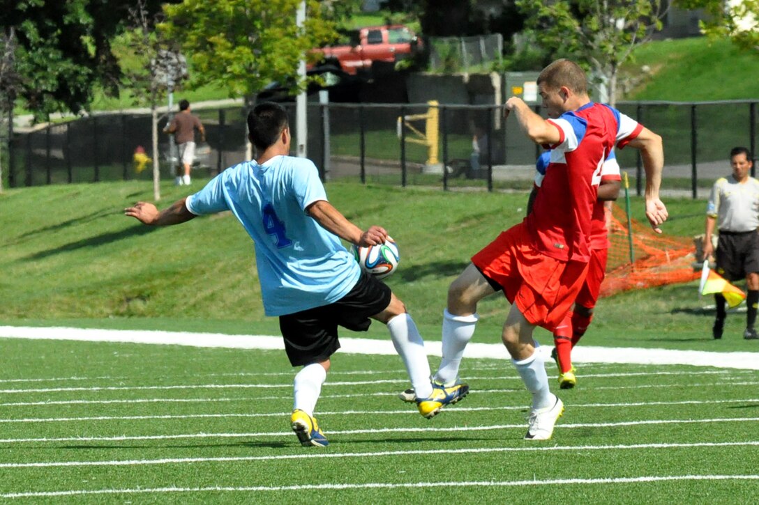 Justin Hines, a midfielder with FC Offutt and U.S. Air Force senior airman with the 55th Aircraft Maintenance Squadron, goes for a loose ball against FC Monterey at the Kroc Center in Omaha, Aug. 16. Hines and his FC Offutt teammates travel to San Antonio over Labor Day weekend to play in the Defenders Cup, an annual military soccer tournament. (U.S. Air Force photo by Ryan Hansen/Released)