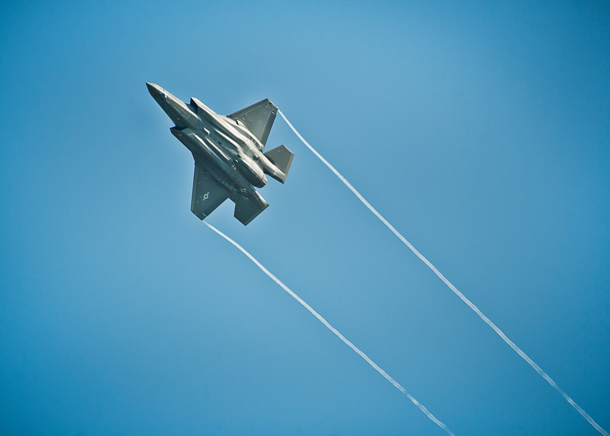 An F-35A Lightning II banks right while flying over the Duke Field runway Aug. 6.  The joint strike fighter landed at Duke for the first time moments later to participate in a joint base exercise.  (U.S. Air Force photo/Tech. Sgt. Sam King)