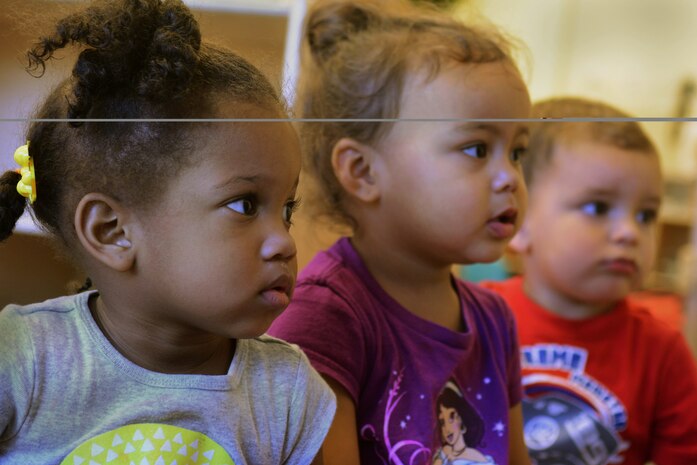 Children listen intently during story time at the Child Development Center on Beale Air Force Base, Calif., Aug. 1, 2014. Parents can use the Beale Parent’s Network for Leasing to find or share temporary openings at the center for children six weeks to five years of age. (U.S. Air Force photo by Staff Sgt. Brenda Davis/Released)