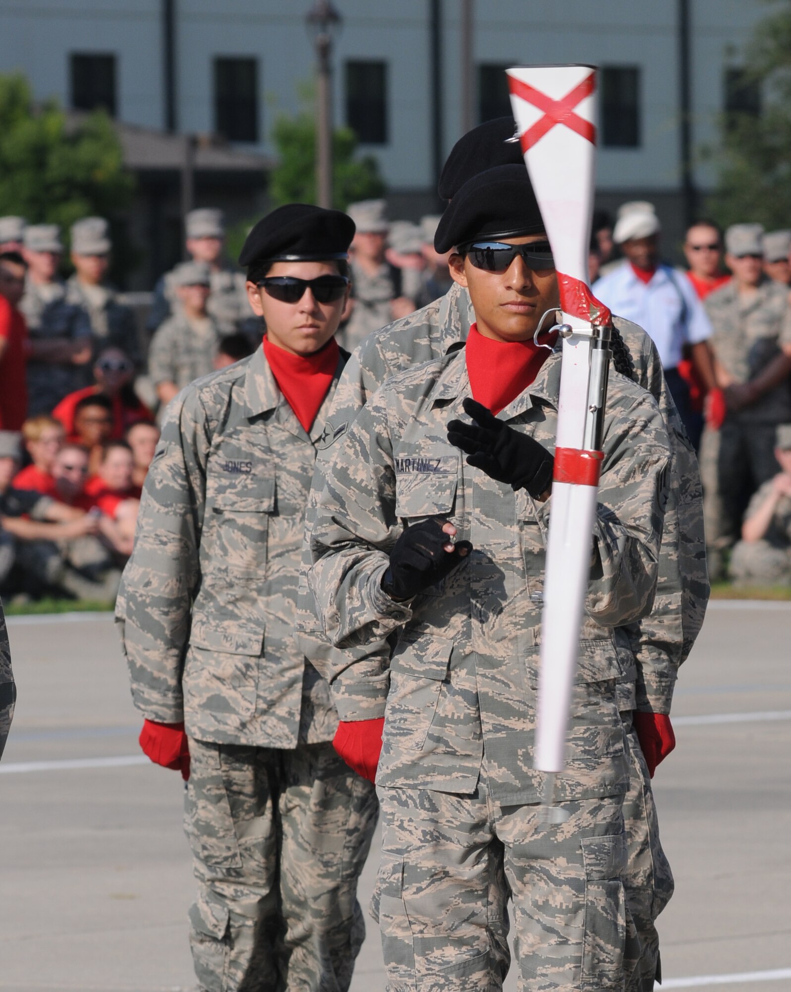Airman 1st Class Moses Martinez, 336th Training Squadron freestyle drill master, leads his team in their performance while spinning a rifle during the 81st Training Group’s drill down competition Aug. 15, 2014, behind the Levitow Training Support Facility at Keesler Air Force Base, Miss.  The 336th TRS “Red Wolves” placed 2nd in freestyle and overall.  (U.S. Air Force photo by Kemberly Groue)