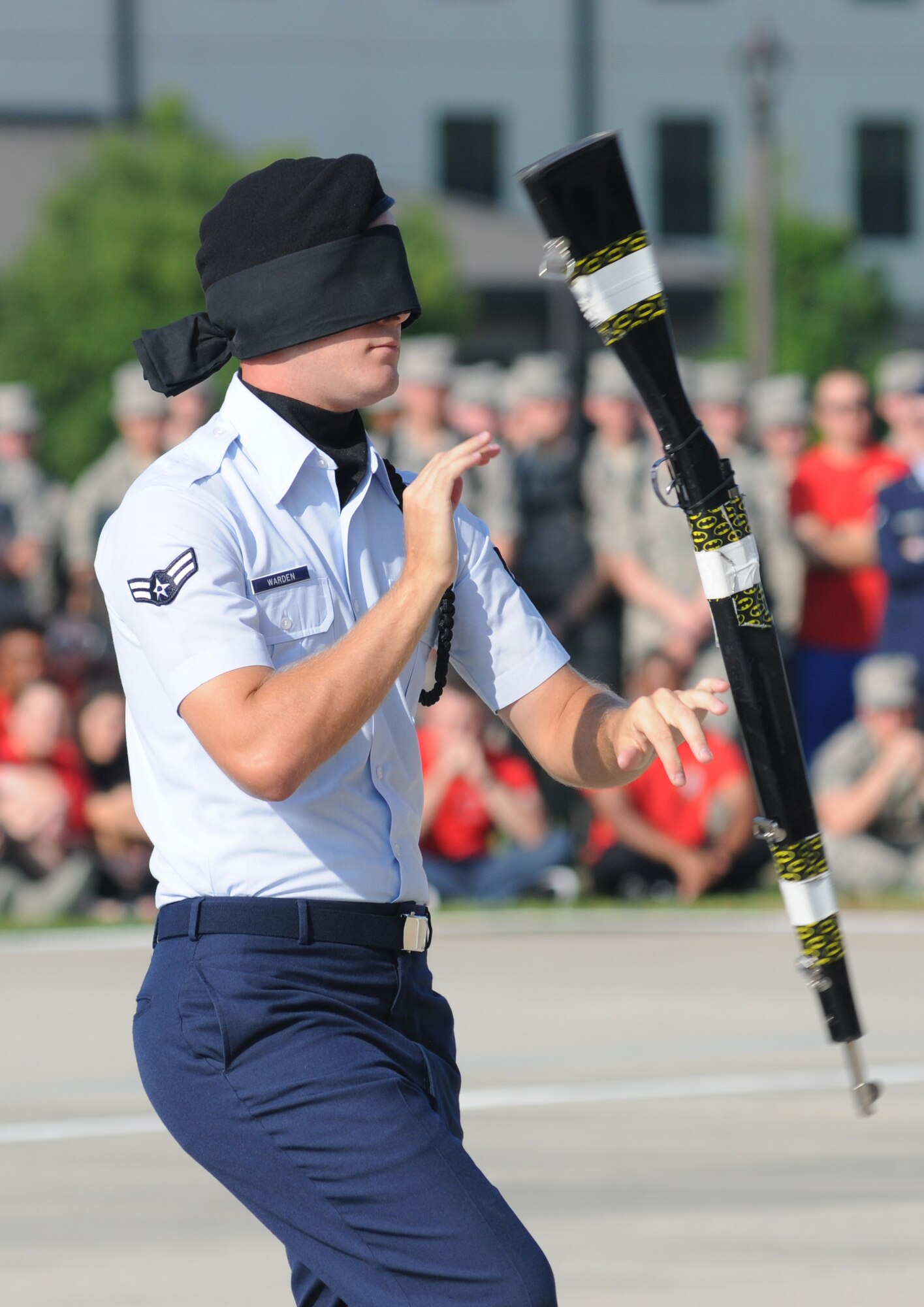 Airman 1st Class Michael Warden, 338th Training Squadron freestyle drill master, leads his team blindfolded as he spins a rifle during the 81st Training Group’s drill down competition Aug. 15, 2014, behind the Levitow Training Support Facility at Keesler Air Force Base, Miss.  The 338th TRS “Dark Knights” placed first in open ranks, freestyle and overall.  (U.S. Air Force photo by Kemberly Groue)