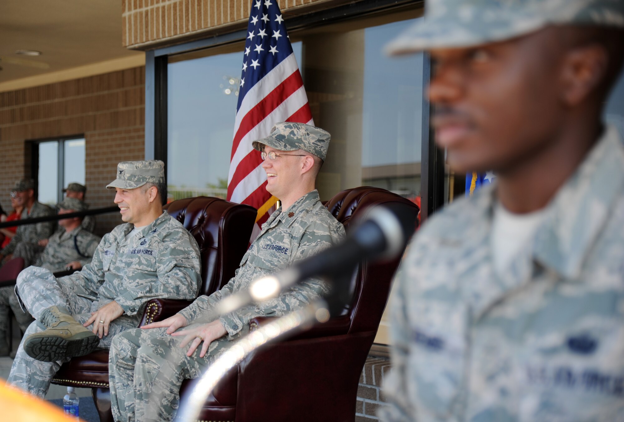 Col. George Tombe, 81st Training Group commander, and Maj. Jonathon Mueller, 81st Training Wing, watch performers from the staging area during the 81st Training Group’s drill down competition Aug. 15, 2014, behind the Levitow Training Support Facility at Keesler Air Force Base, Miss.  Mueller served as the presiding officer for the event.  (U.S. Air Force photo by Kemberly Groue)